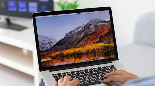 Customer examining MacBook Pro features before buying at PayMore Alafaya