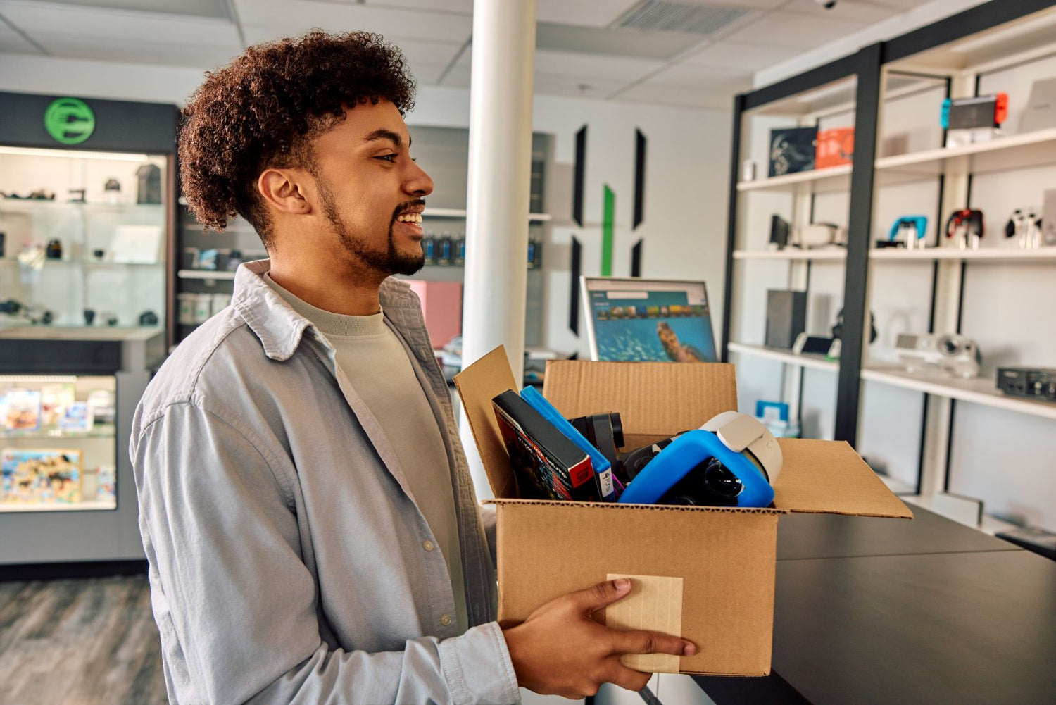 man selling a box of electronics
